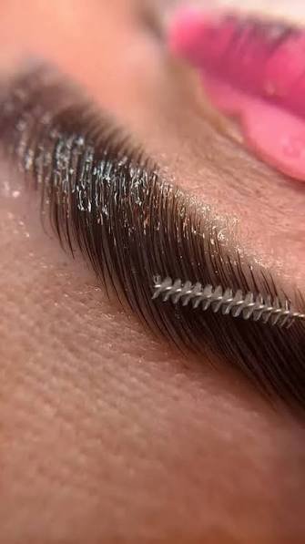 Close-up of a lash extension being applied at AK Beauty